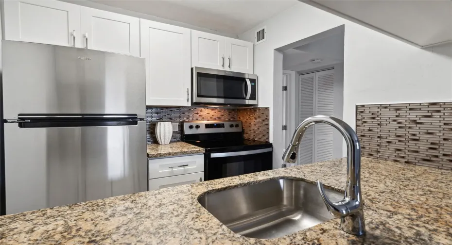 New cabinets, marble counters 
tile backsplash and stainless appliances