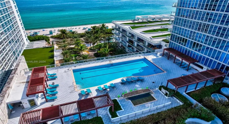 The epitome of luxury at Miami Beach's 5 Star resort, Carillon Miami Wellness Resort where residents enjoy beach amenities including complimentary chaises and umbrellas.