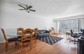 Open, bright living room with impact sliders (4 years old) and split AC (5 years old).