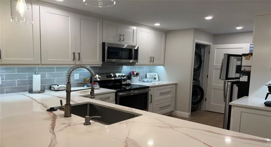 beautiful updated kitchen with washer/dryer in closet