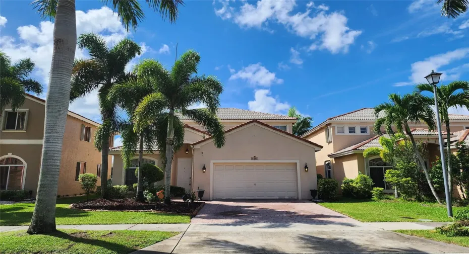 GORGEOUS 2-STORY HOME SWEET HOME!  Front North exposure, paved driveway laced w/ palm trees!