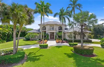 Spacious front yard with circular drive and landscape lighting