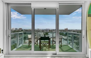 Comfortable and relaxing, with breathtaking views! This spacious balcony invites you to take in the vibrant South Beach city views.