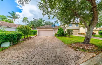 Brick driveway with room for additional vehicles.